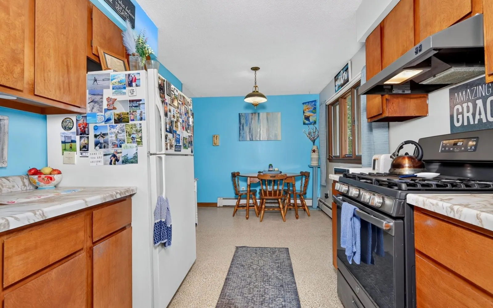 Kitchen with wood cabinets and a window over the sink
