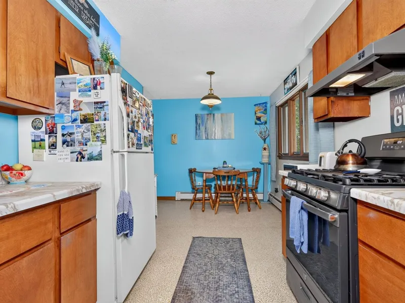 Kitchen with wood cabinets and a window over the sink
