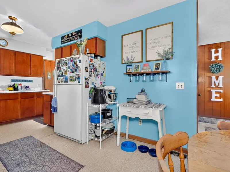 Kitchen with wood cabinets and a dining table