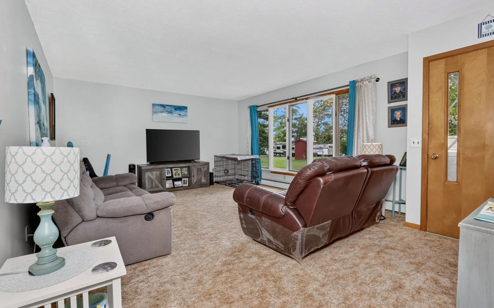 Wood-paneled living room with a ceiling fan