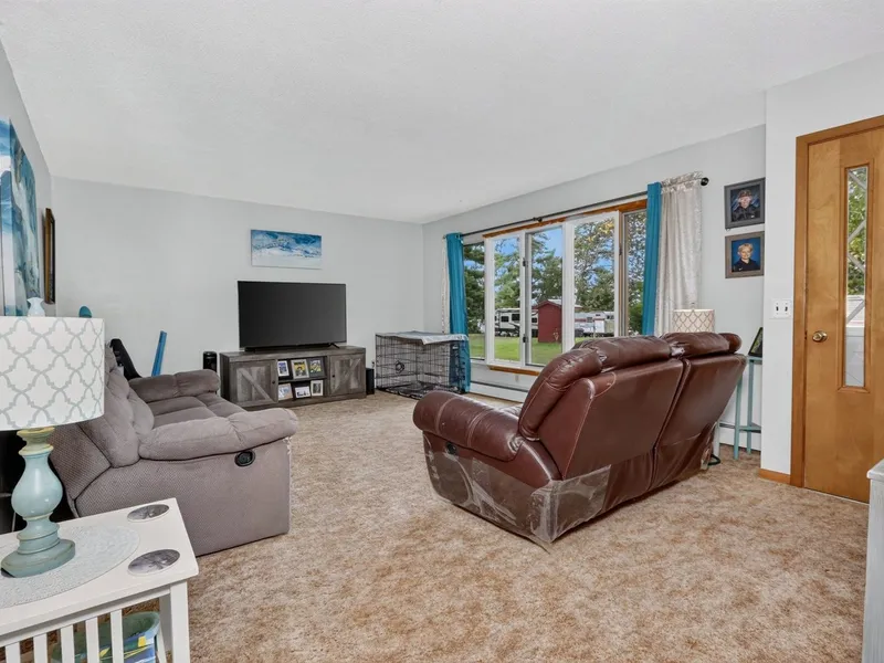 Wood-paneled living room with a ceiling fan