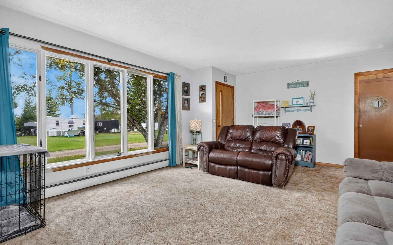 Wood-paneled living room with windows
