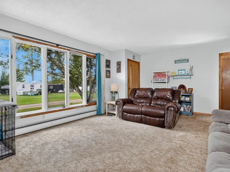 Wood-paneled living room with windows