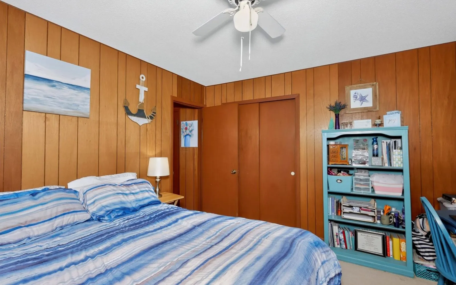 Bedroom with wood paneling and a window