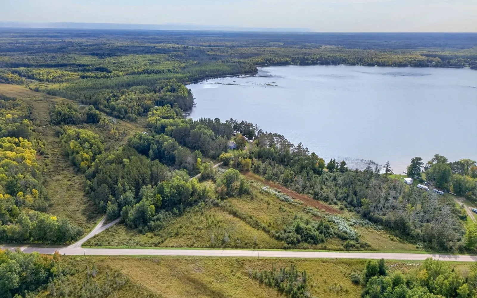 Aerial view of the house, yard, and lake