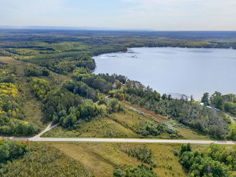 Aerial view of the house, yard, and lake